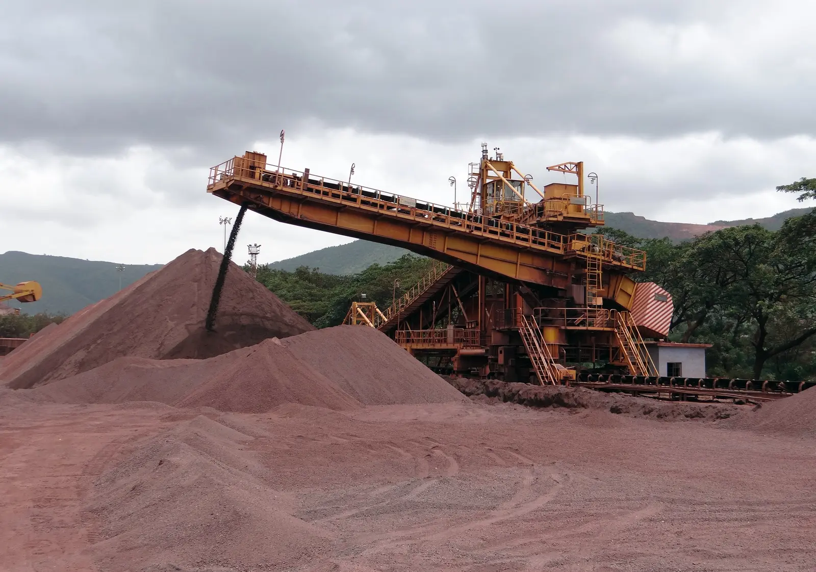 Iron ore stockpile and stacker-reclaimer at a mine